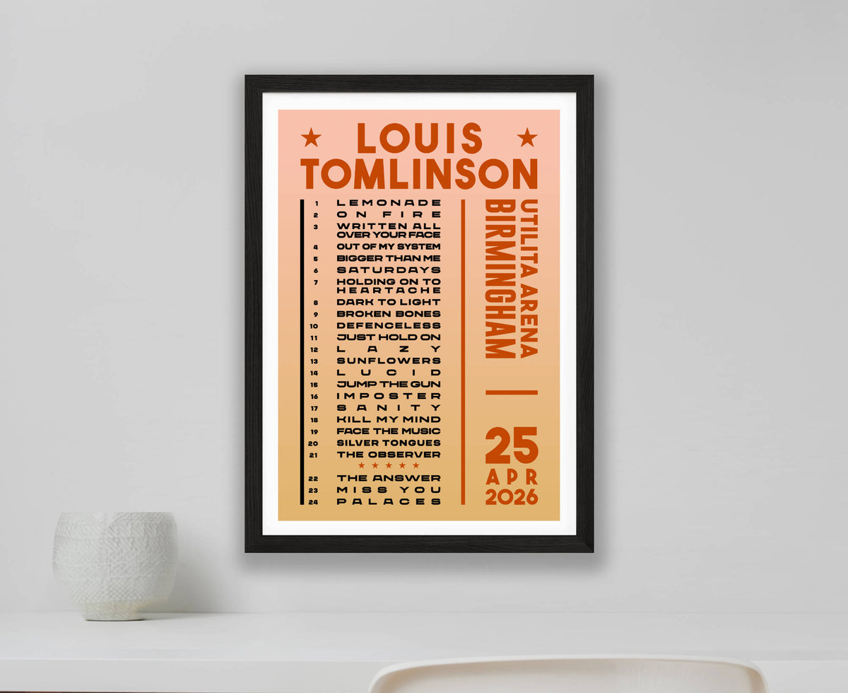A Louis Tomlinson concert setlist poster for Birmingham gig on 25 April 2026. Displayed in a frame on a white wall above a white desk.